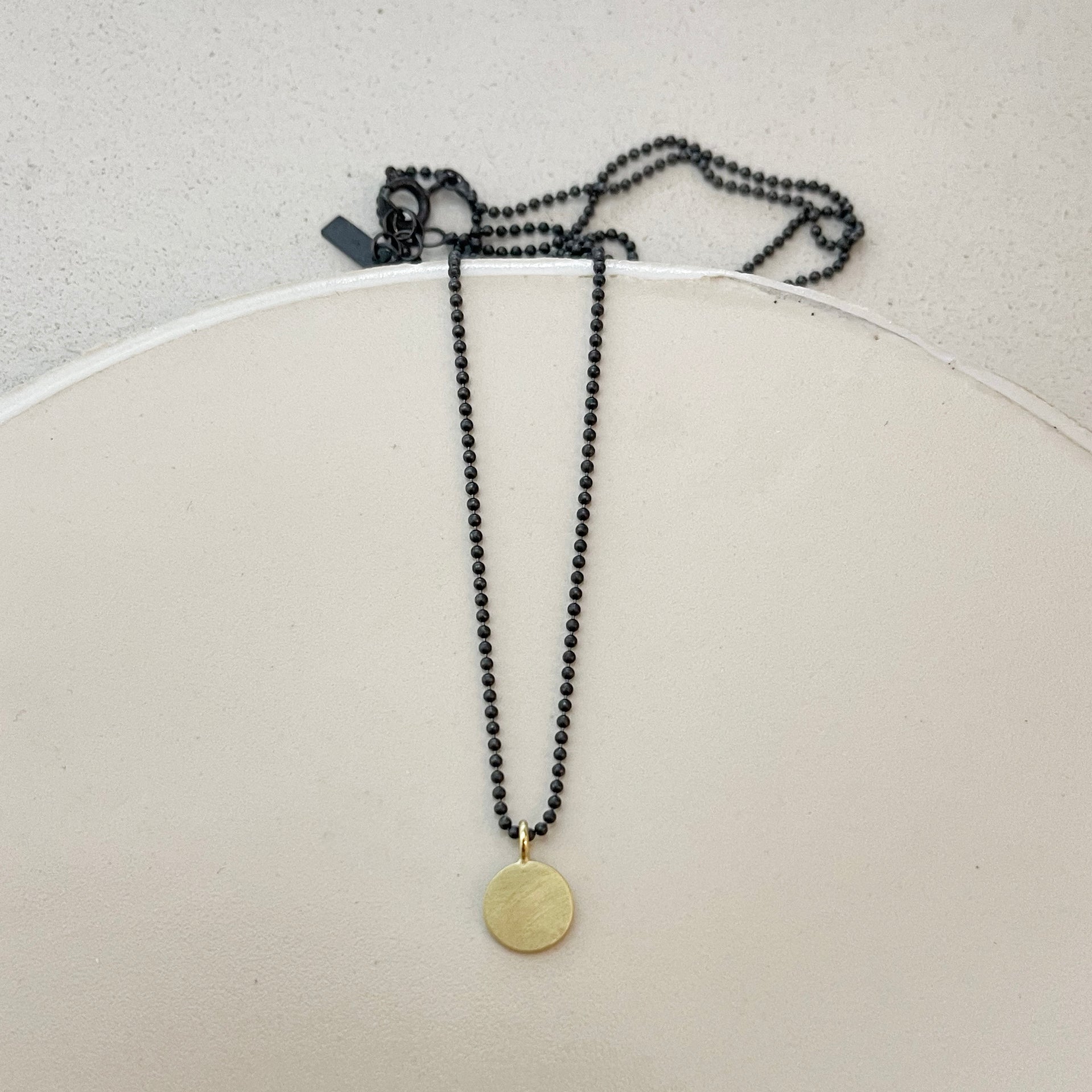 Flat disk with ball chain necklace