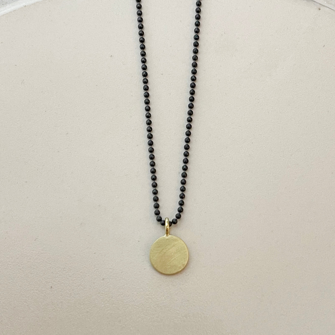Flat disk with ball chain necklace